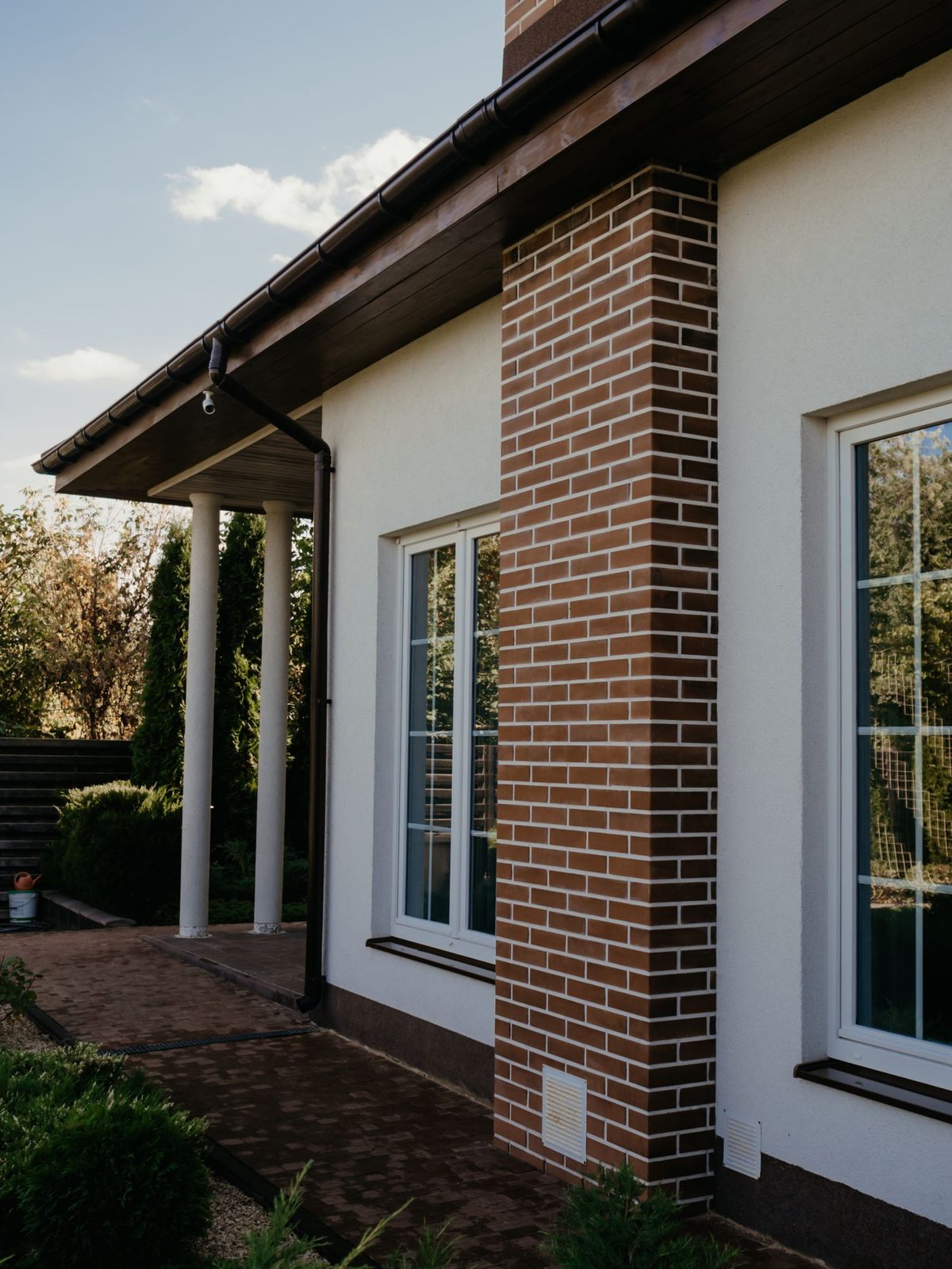 Newly fitted white casement windows in a clean rendered wall