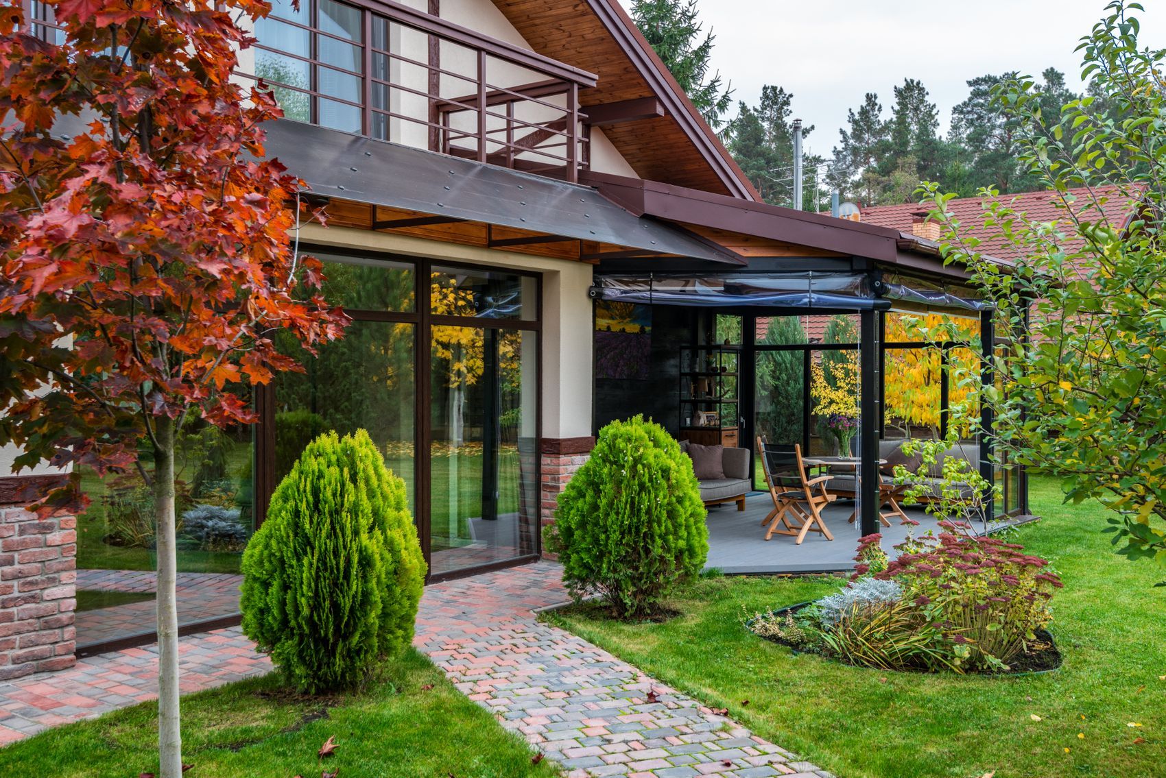 A conservatory built onto a house, looking across the garden