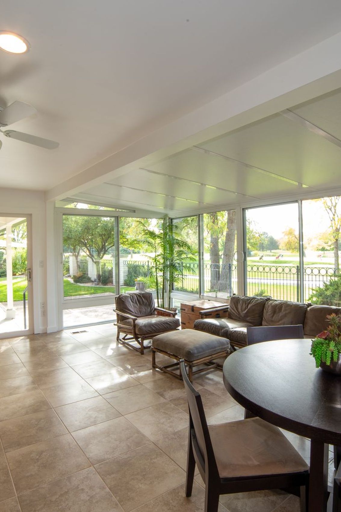 Wide glazed doors opening from a garden room onto the lawn