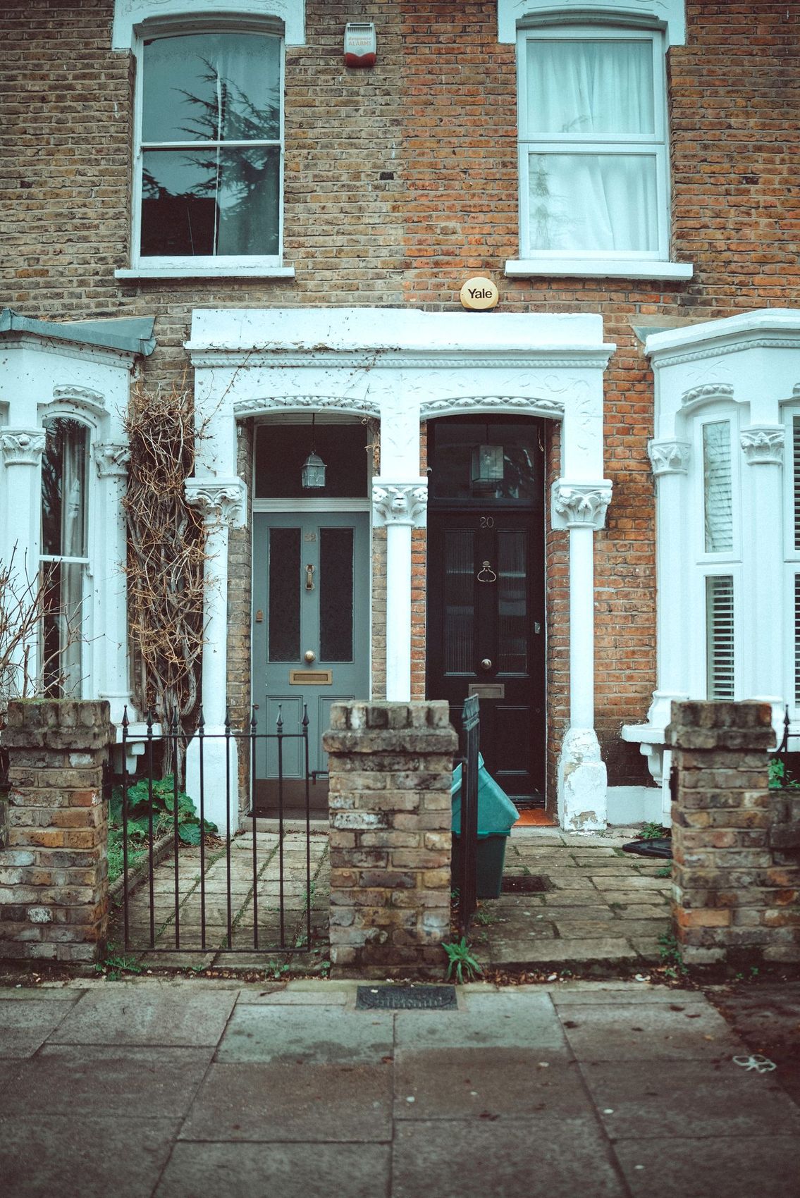 Painted front doors on a pastel-coloured terrace