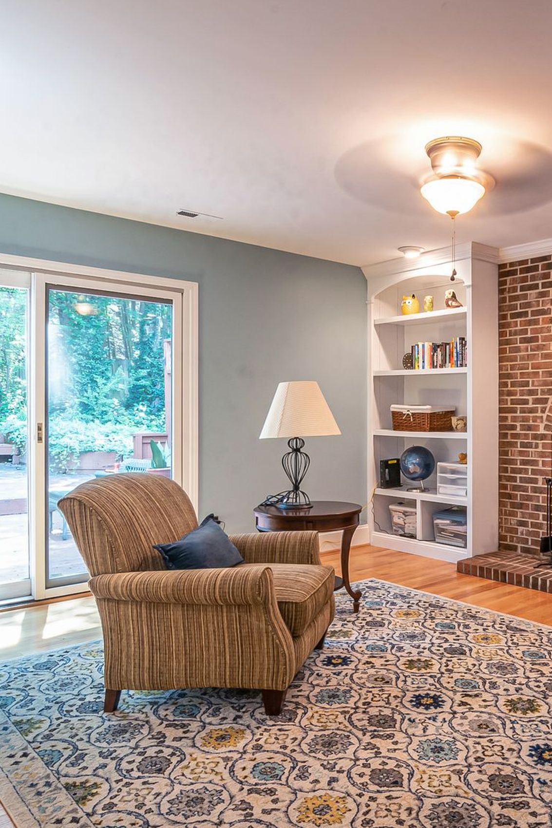 A living room with wide sliding patio doors onto the garden