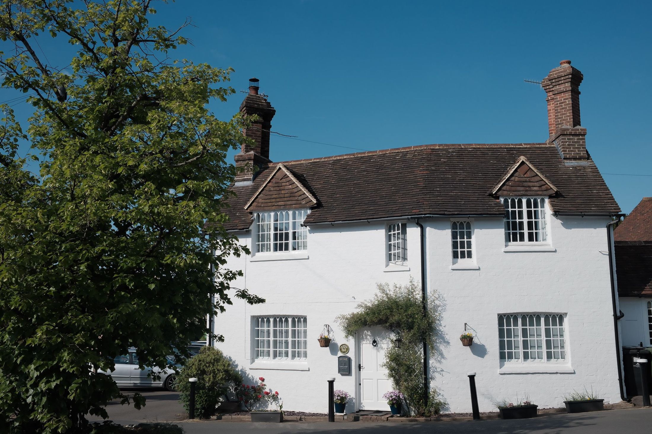 A row of white-rendered village houses in bright sunshine