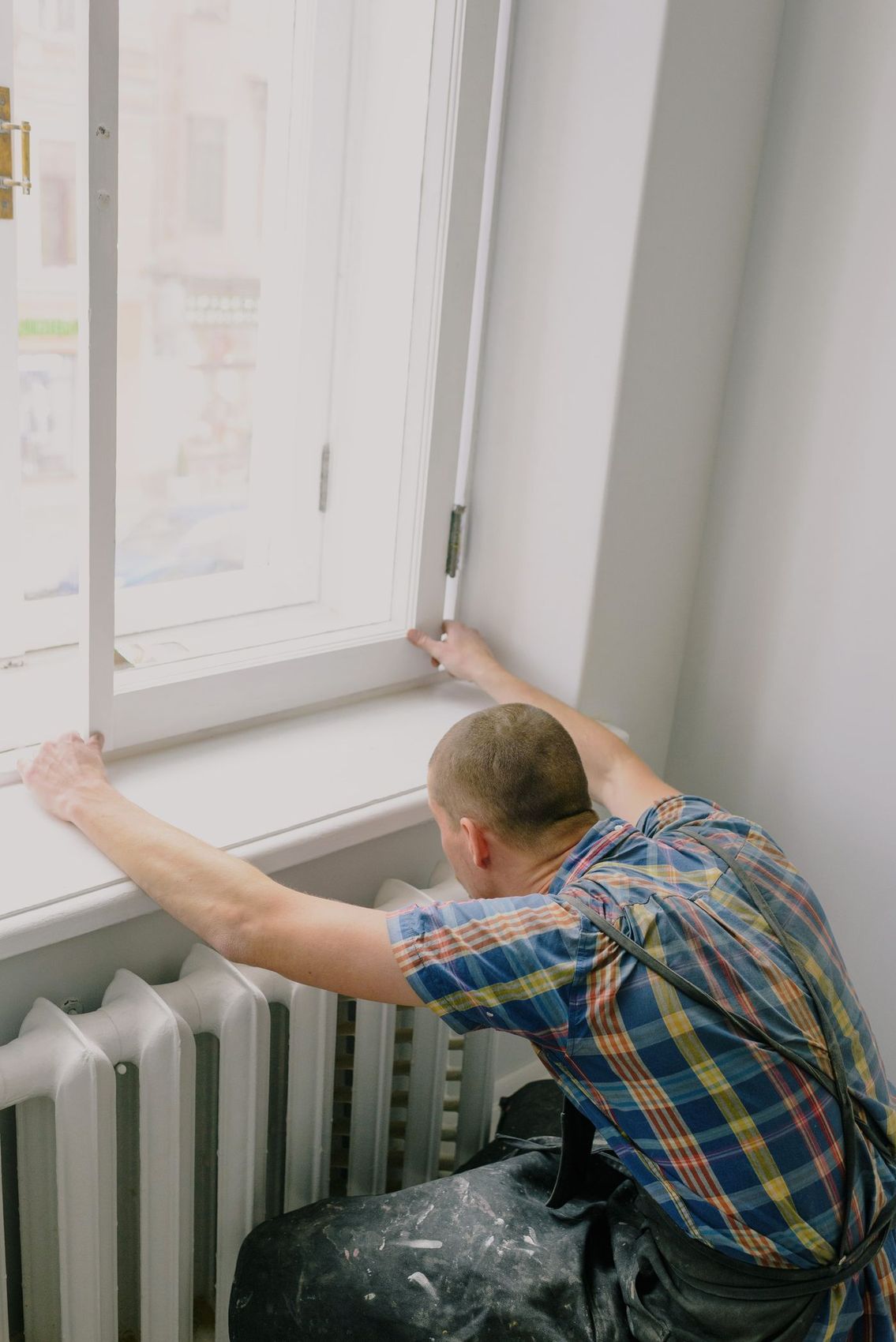 A fitter working at a window opening