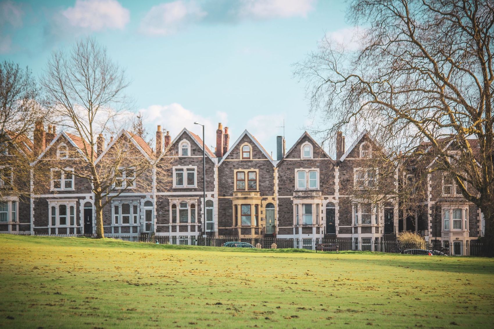 A row of bay-fronted Victorian terraced houses on a British street